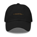 Claude Code Spinner Dad Hat - Canoodling - Black dad hat with orange embroidered text