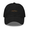 Claude Code Spinner Dad Hat - Noodling - Black dad hat with orange embroidered text