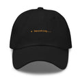 Claude Code Spinner Dad Hat - Smooshing - Black dad hat with orange embroidered text