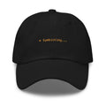 Claude Code Spinner Dad Hat - Symbioting - Black dad hat with orange embroidered text