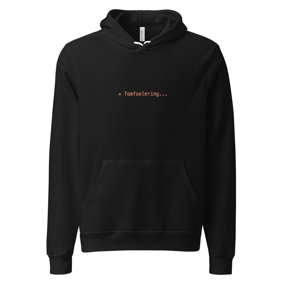 Black hoodie with orange text reading ✳ Tomfoolering...